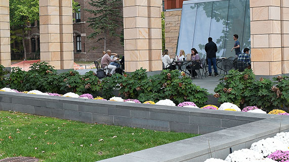 students sitting outside of the Ross building