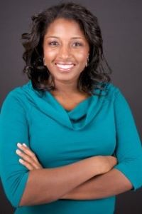 Photo of Michigan Ross Executive MBA student Antoinette (Toni) Chukudebelu. She has medium length dark hair and is wearing a teal colored top. She has her arms crossed and she is smiiling.
