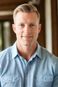 Photo of Michigan Ross Online MBA student Carey Peekstok. He has blond hair and is wearing a light blue button-down shirt. He is smiling.