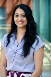 Photo of Meghna Jain Michigan Ross Weekend MBA student. She is wearing a light blue shirt and has long dark hair, and she is smiling.