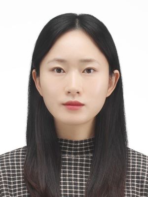 Bomi Kim poses for a headshot photo in a formal checkered shirt in front of a white background