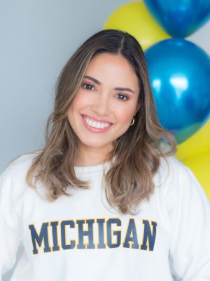 Claudia in a headshot with balloons in the background