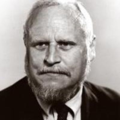 Black and white photo of  a professor in a suit