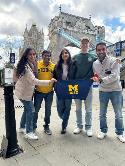 Students pose with the Ross flag in front of the London Tower Bridge.