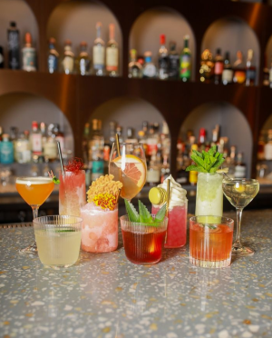 Colorful cocktails with garnishes on a bar
