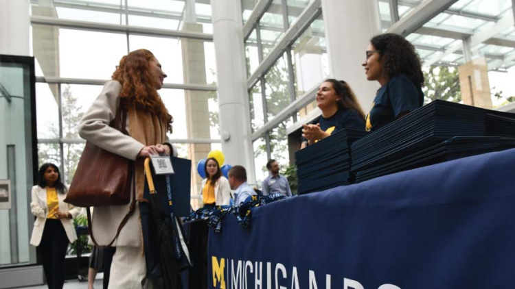 A student talking to a panel at Michigan Ross