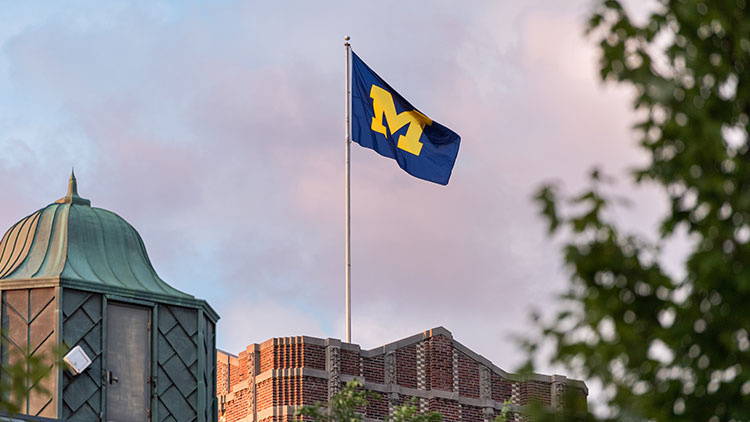 university of michigan flag on top of building