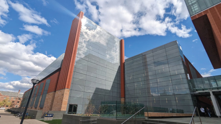 The Ross building, with a bright blue sky full of clouds above.