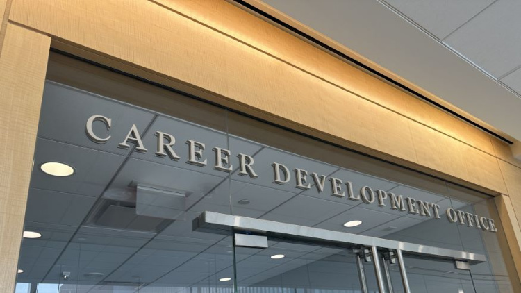 Photo of the exterior of the Michigan Ross Career Development Office. The words Career Development Office are in silver letters on the window of the office. 