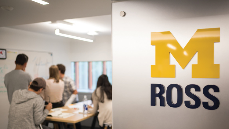 University of Michigan Ross logo with students collaborating at a whiteboard in the background.