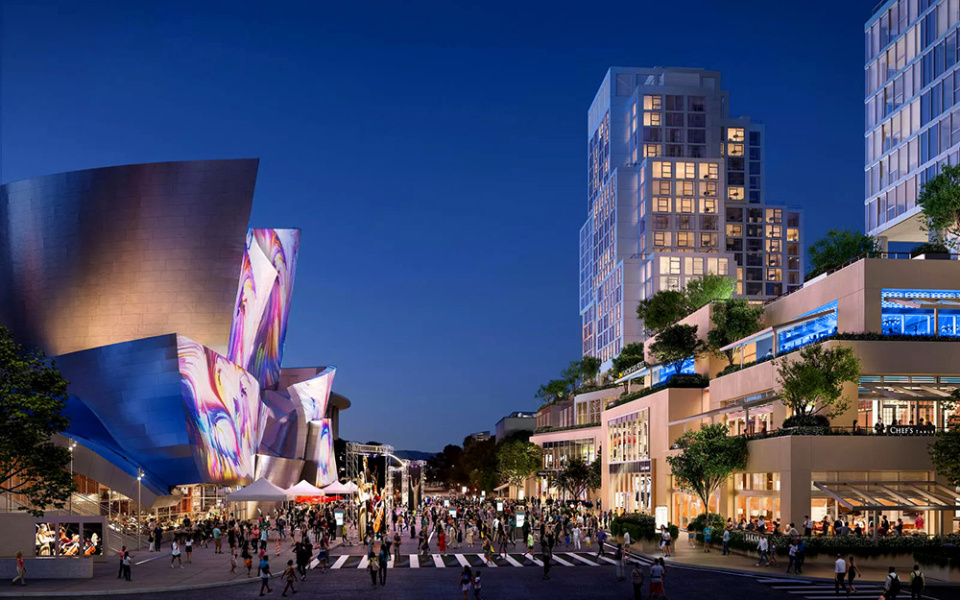 Vibrant cityscape at dusk with illuminated buildings. A modern, reflective structure on the left hosts colorful lights, while bustling crowds engage on the lively street below, conveying an energetic urban atmosphere.