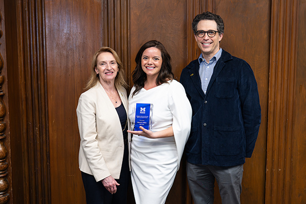 3 people posing with award. One of them is Dean Matusik