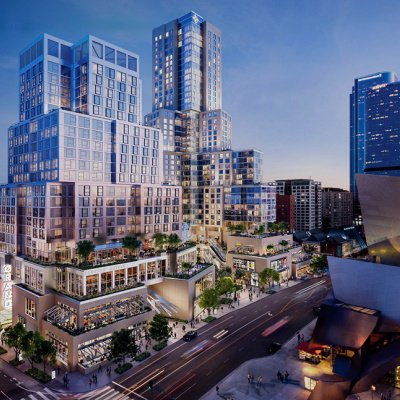 A modern cityscape at dusk featuring a complex of geometric skyscrapers with lit windows. Streets below are animated with traffic and people, evoking a lively urban atmosphere.