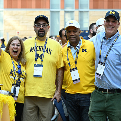 4 people smile and cheer for the camera