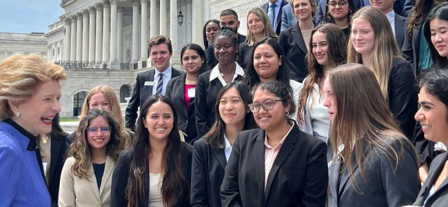 Large group of students standing on steps in Washington DC greeting political figure