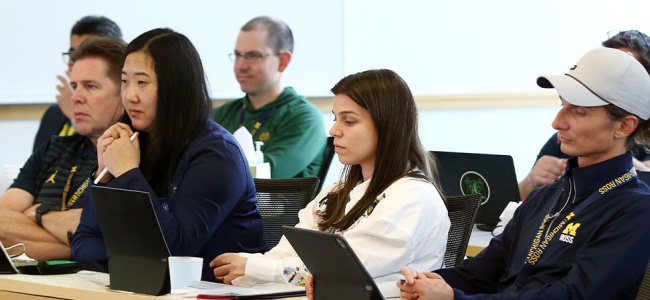 group of students listening intently in classroom setting