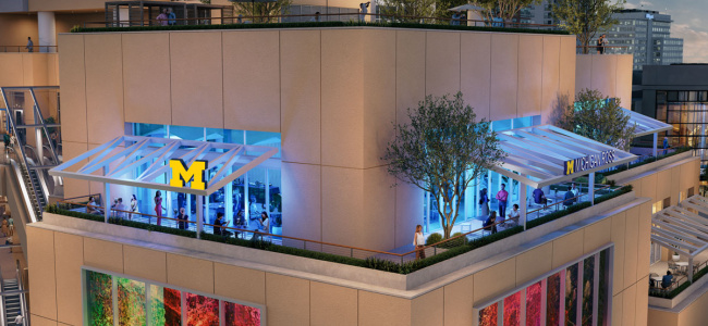 A rooftop event space with a University of Michigan logo on the glass facade.