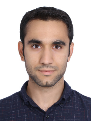 Yasin Taghvaee poses for a headshot in a dark colored shirt