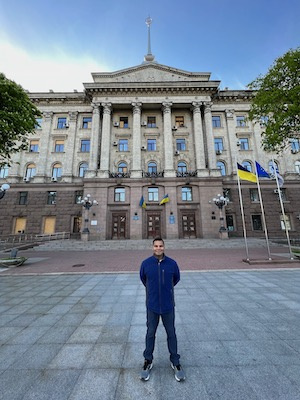 Man standing in front of large building in Ukraine
