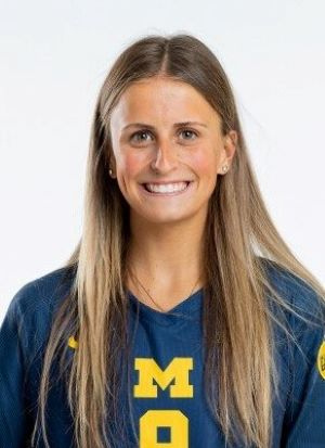 Blonde woman in maize and blue uniform on a white background
