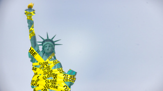Statue of liberty wrapped in yellow caution tape