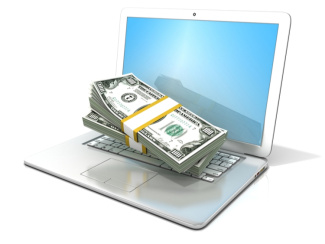 Laptop with pile of money