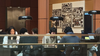 Students sitting at a study table at the Ross School of Business. 