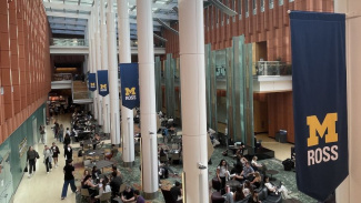 Photo of Ross School of Business Winter Garden with a lot of students sitting at tables and talking and studying. 