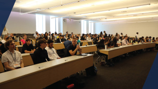 A large group of students in a classroom learning together
