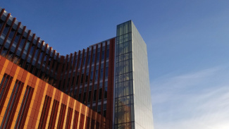 An image of the exterior of the Ross building, set against a blue sky at either sunrise or sunset