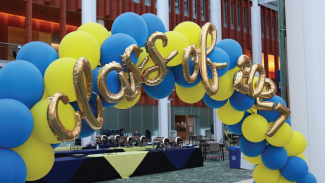 Maize and blue balloon arch that says "Class of 2027"
