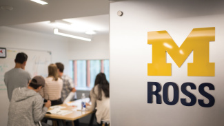 University of Michigan Ross logo with students collaborating at a whiteboard in the background.