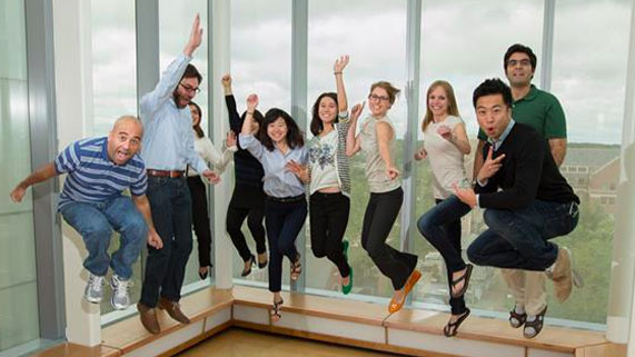 PhD students at Michigan Ross jumping in the air