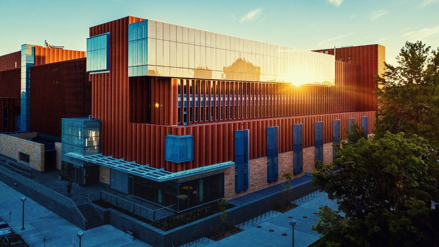 Photo of exterior of the Michigan Ross building as the sun is setting. 