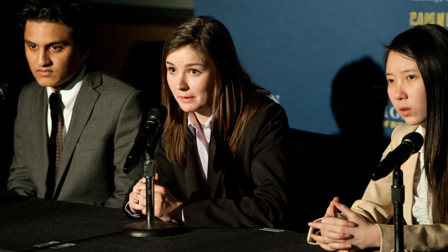 Students during a case competition - talking on stage to crowd