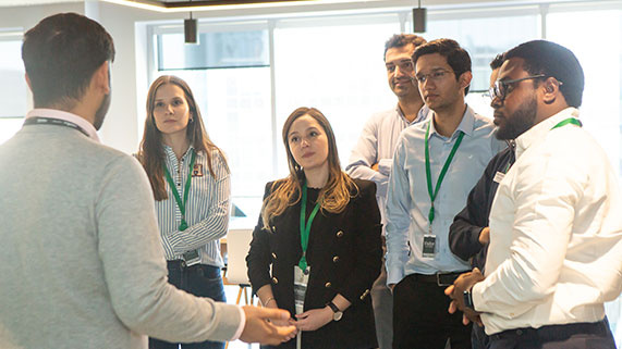 group of people listening to another person all in business apparel 