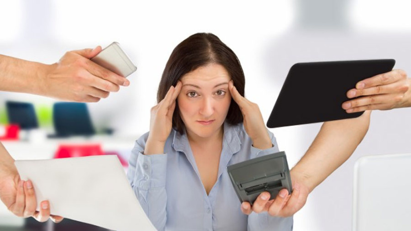 woman stressed out with many objects being handed to her