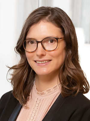 professional portrait picture of a smiling woman wearing glasses