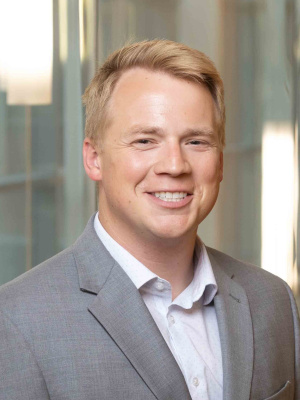 Male in suit smiling at camera