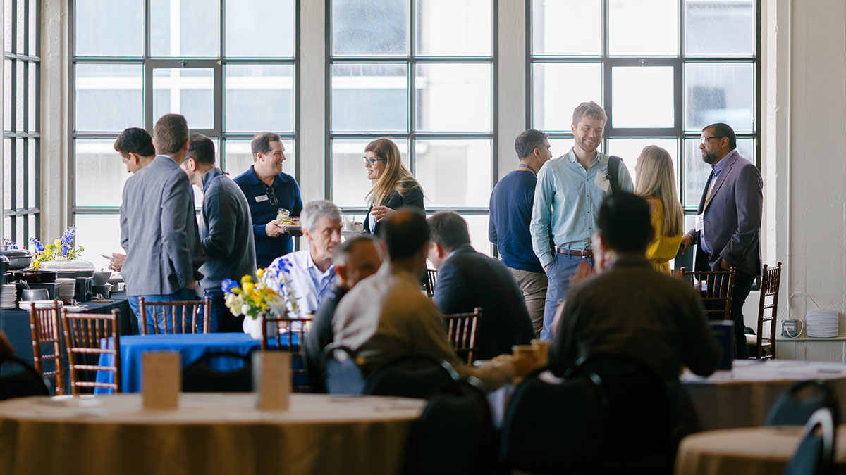 Innovation Conference Attendees Chat During the Break