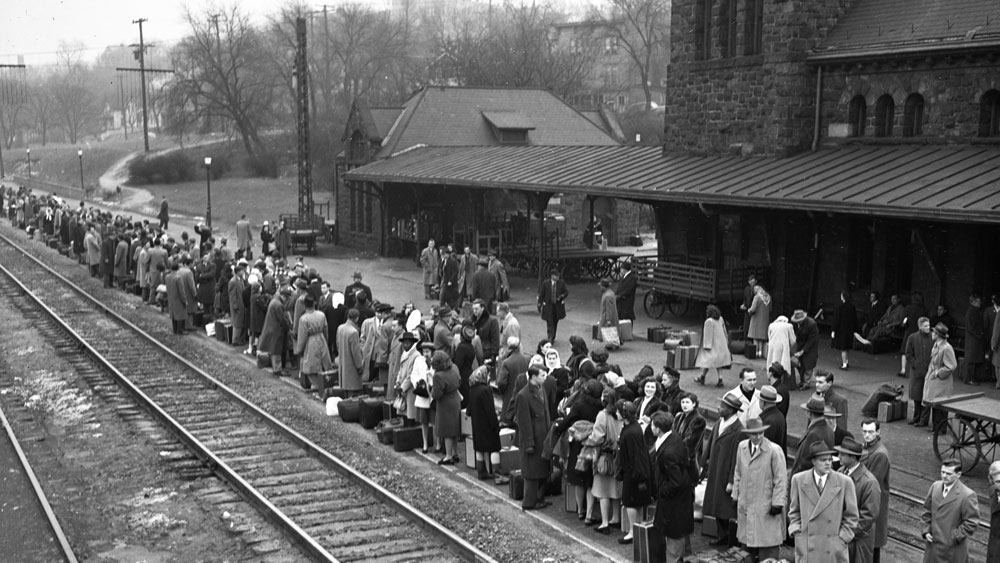 Students wait at the station for the special west-bound train to take them home for Christmas, December 1946 