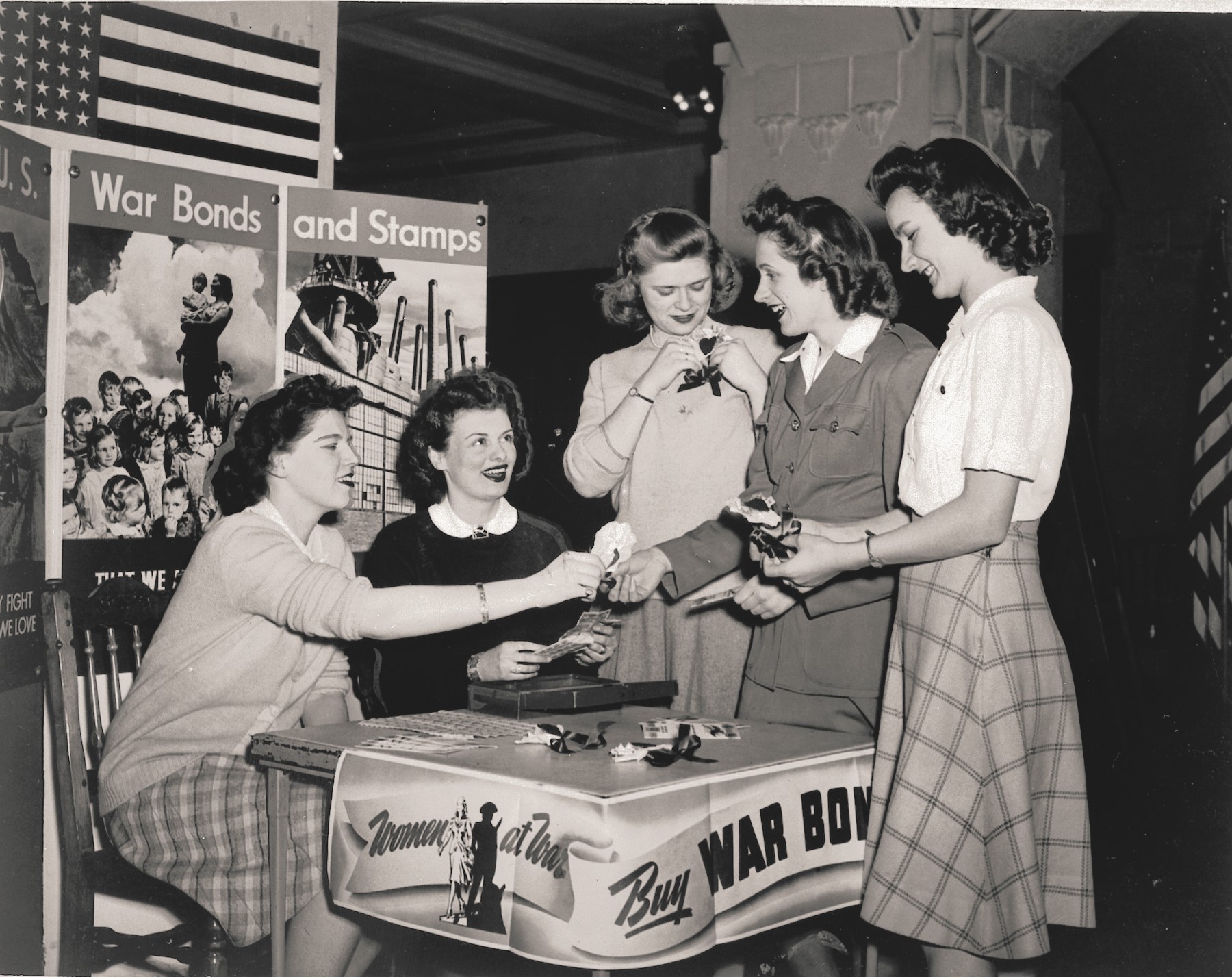 Women at a table selling war bonds