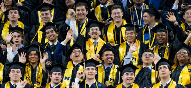 group of students in commencement grab celebrating