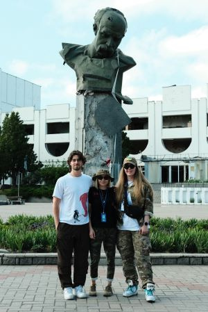 Ross and colleagues standing in front of a statue in Ukraine