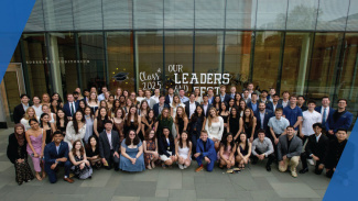 A large crowd of students taking a group photo in front of the Ross Building