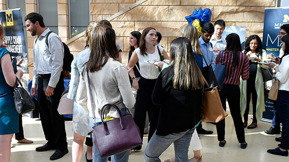 large group of people talking at event