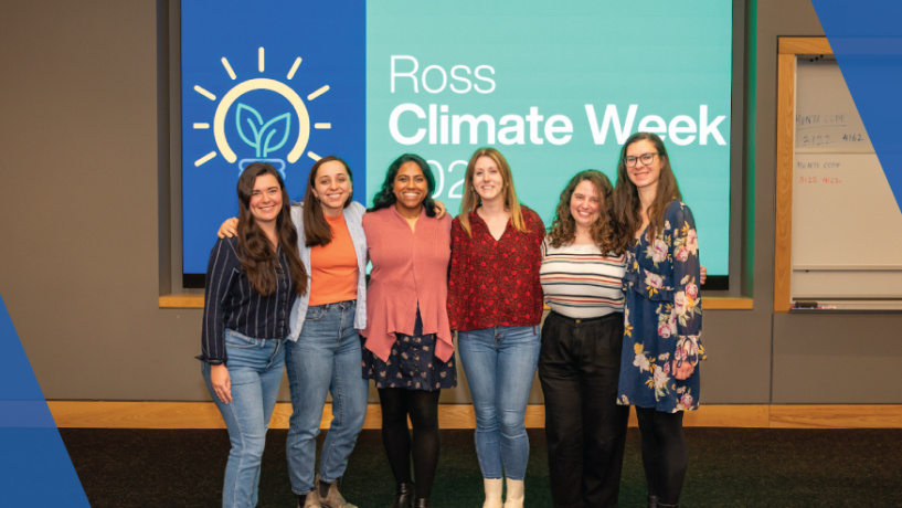 The six organizers for Climate week pose together in casual clothes in front of a screen that reads "Ross Climate Week" in a classroom or lecture hall